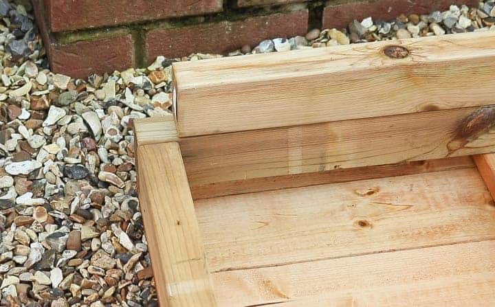lining up pressure treated timber for base of shed