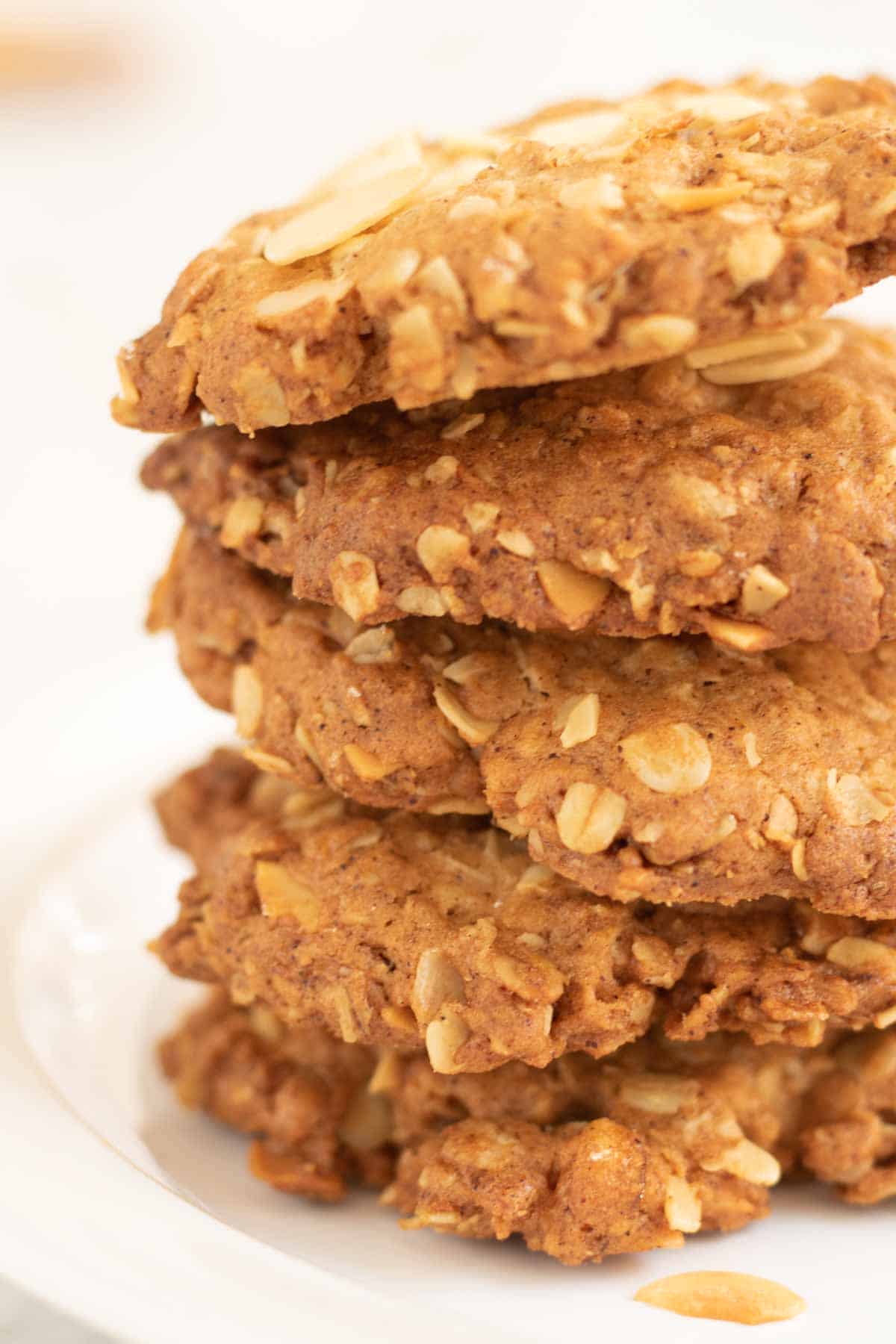 Close up of stacked oaty biscuits with almonds, mixed peel and ground mixed spice using leftover Christmas cake baking ingredients