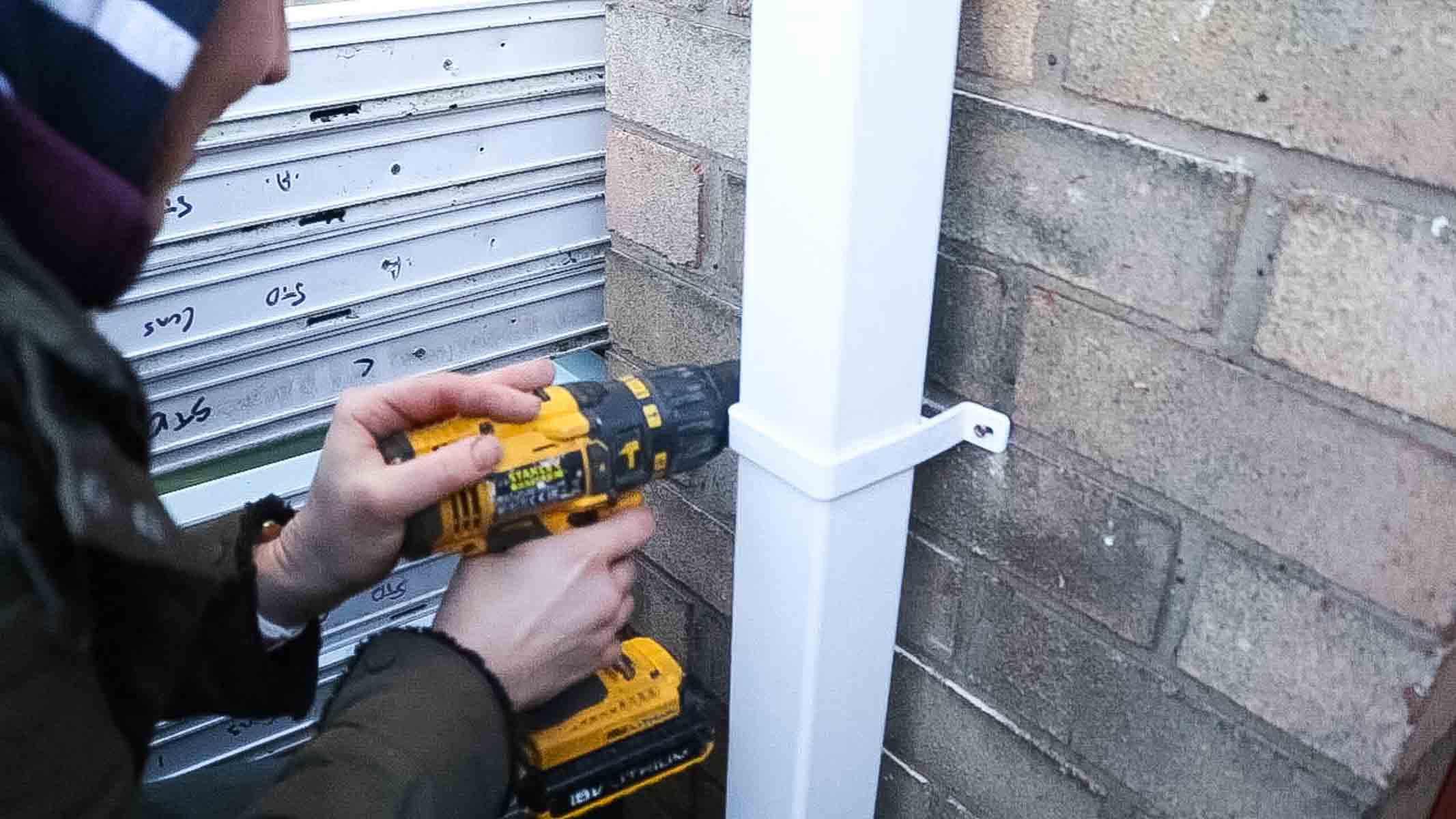 mounting down pipe to brick wall with guttering clips