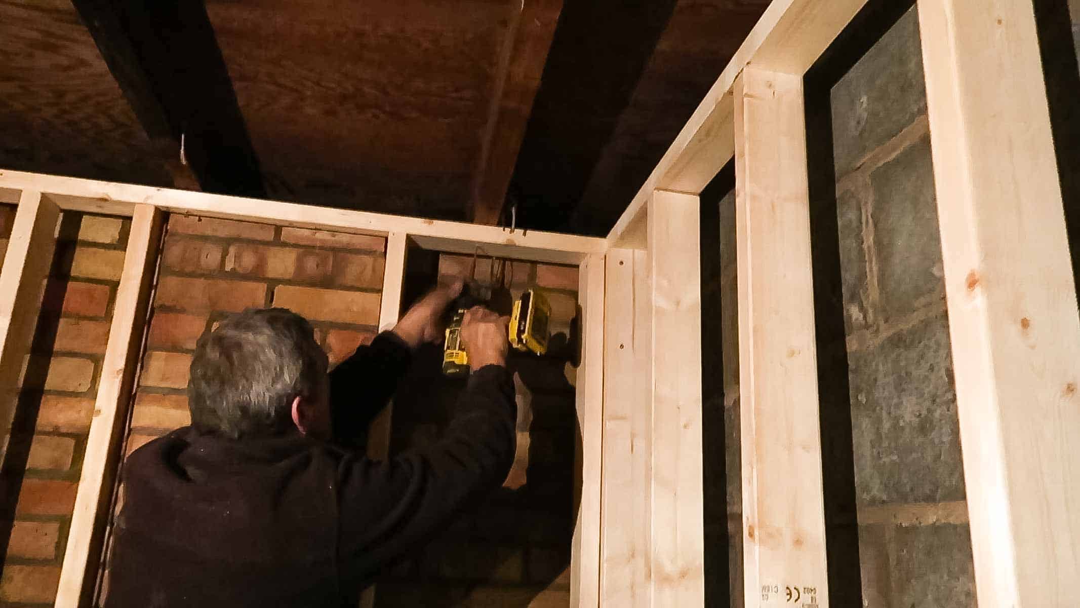 screwing studded wall frame to the ceiling