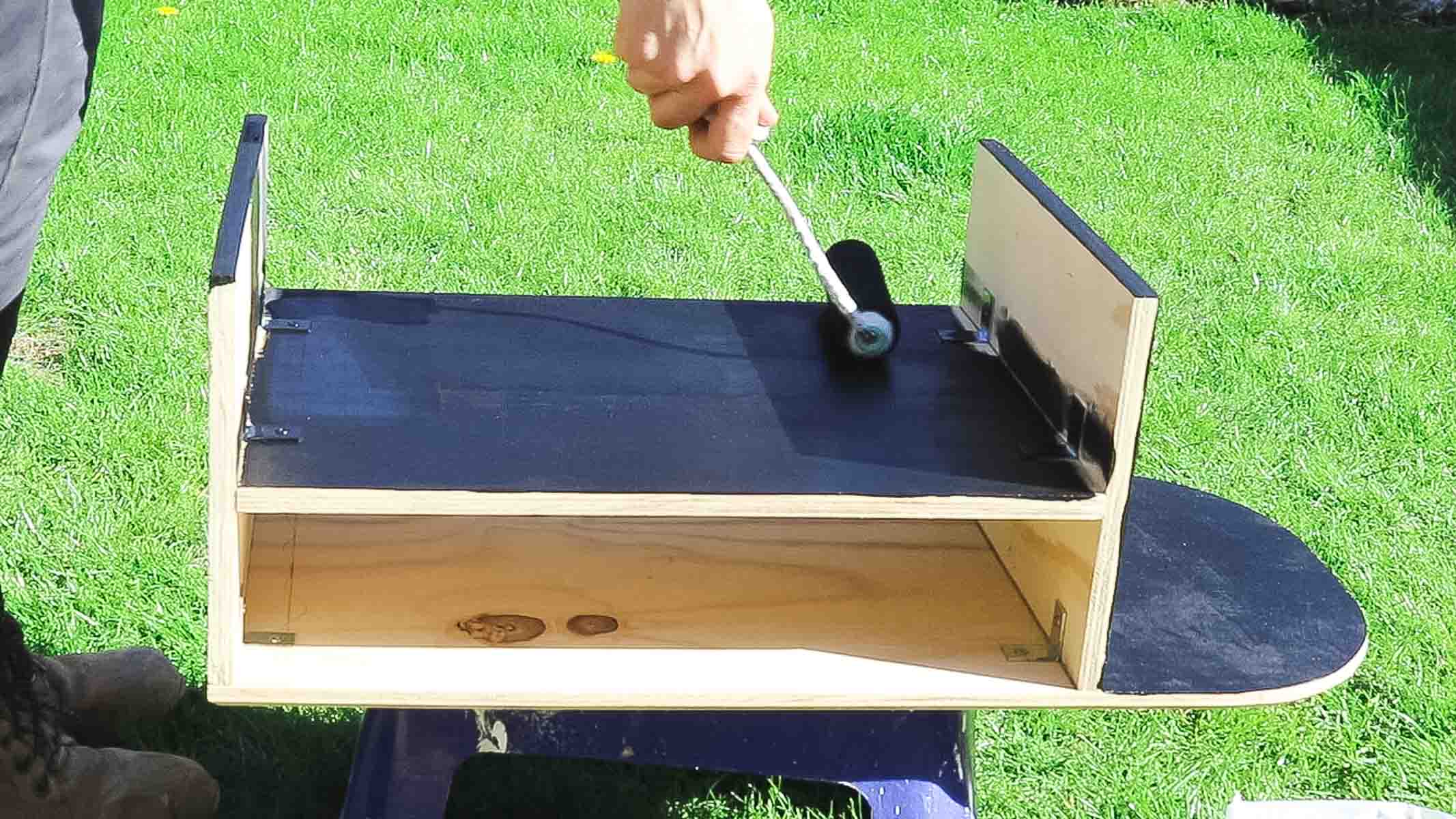 Painting a black standing desk using Rustoleum paint with a mini foam roller