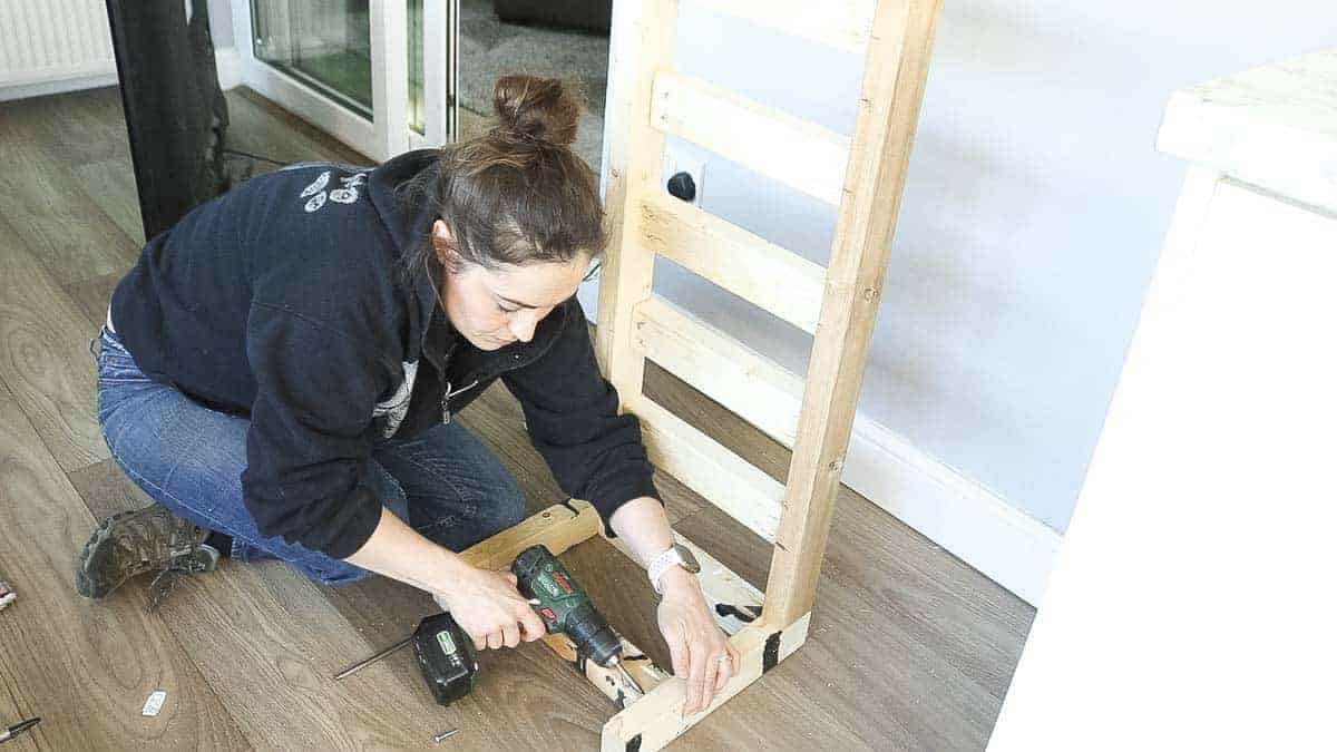 Screwing supports on TV stand legs