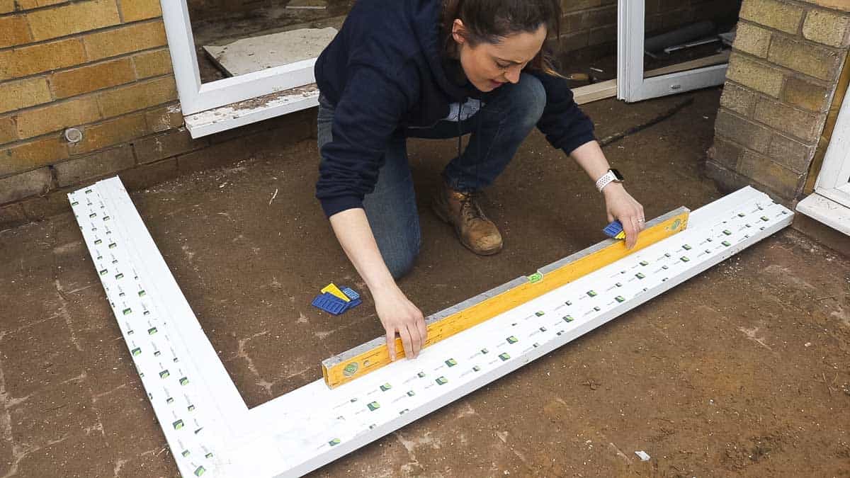 Making UPVC window sil level with a spirit level and packers.