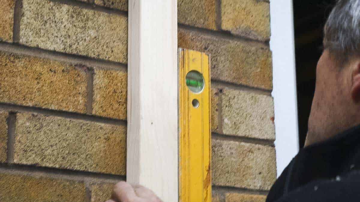 Straightening structural timber against house