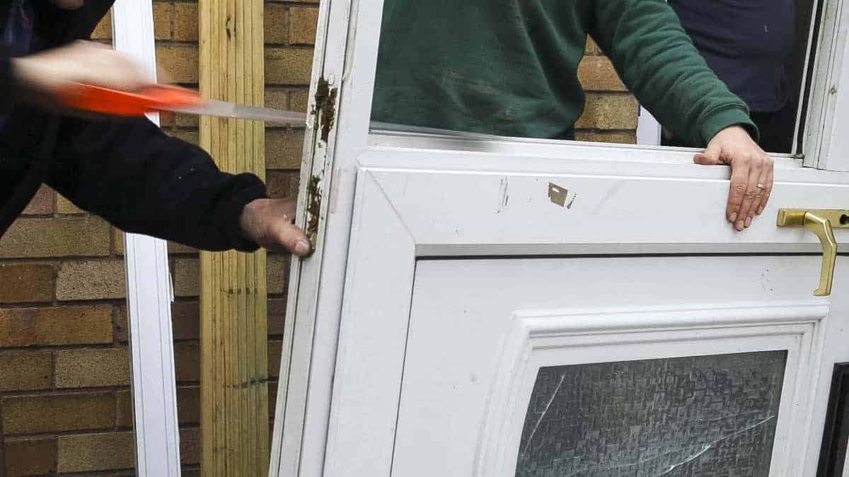 Hand sawing excess of UPVC door frame from an ex display.