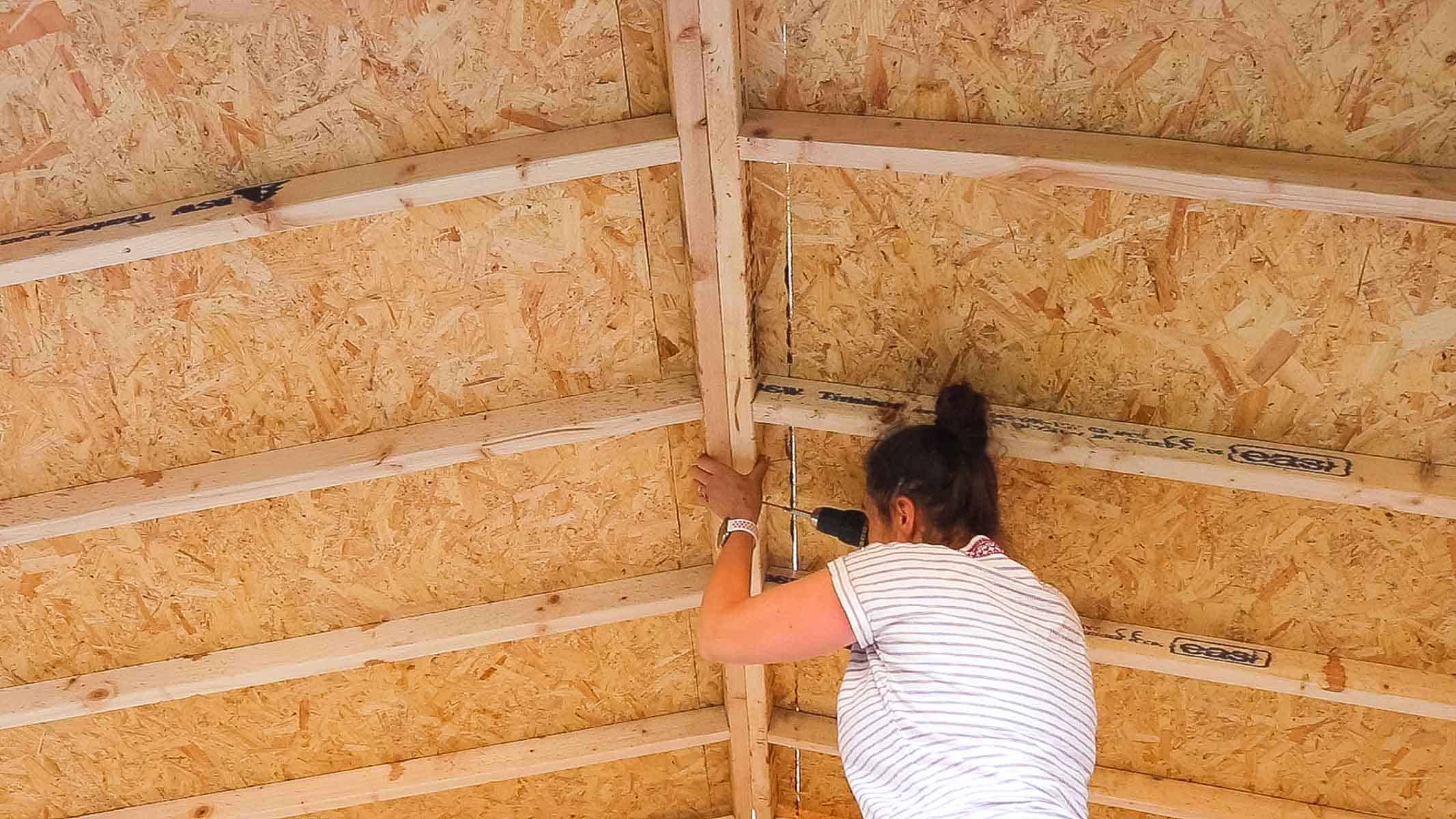 The Carpenter's Daughter screwing shed roof sections together