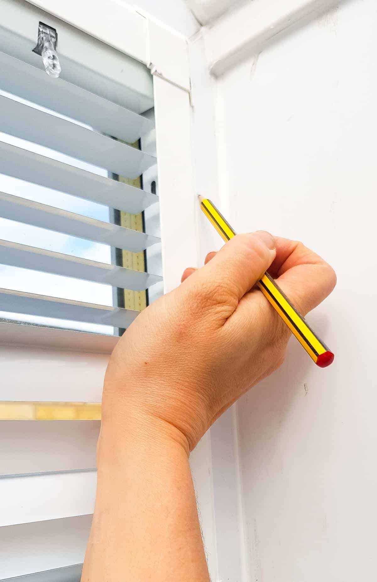 marking windows with pencil for perfect fit blinds brackets