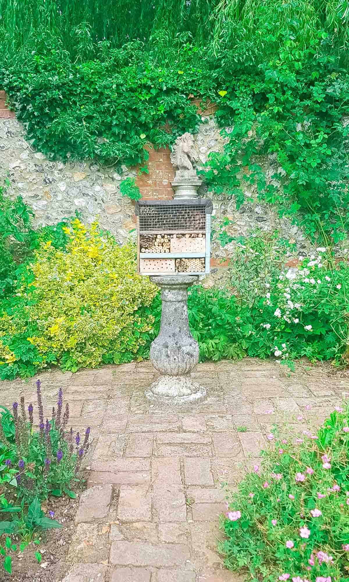 bee and insect house on a stand in a garden