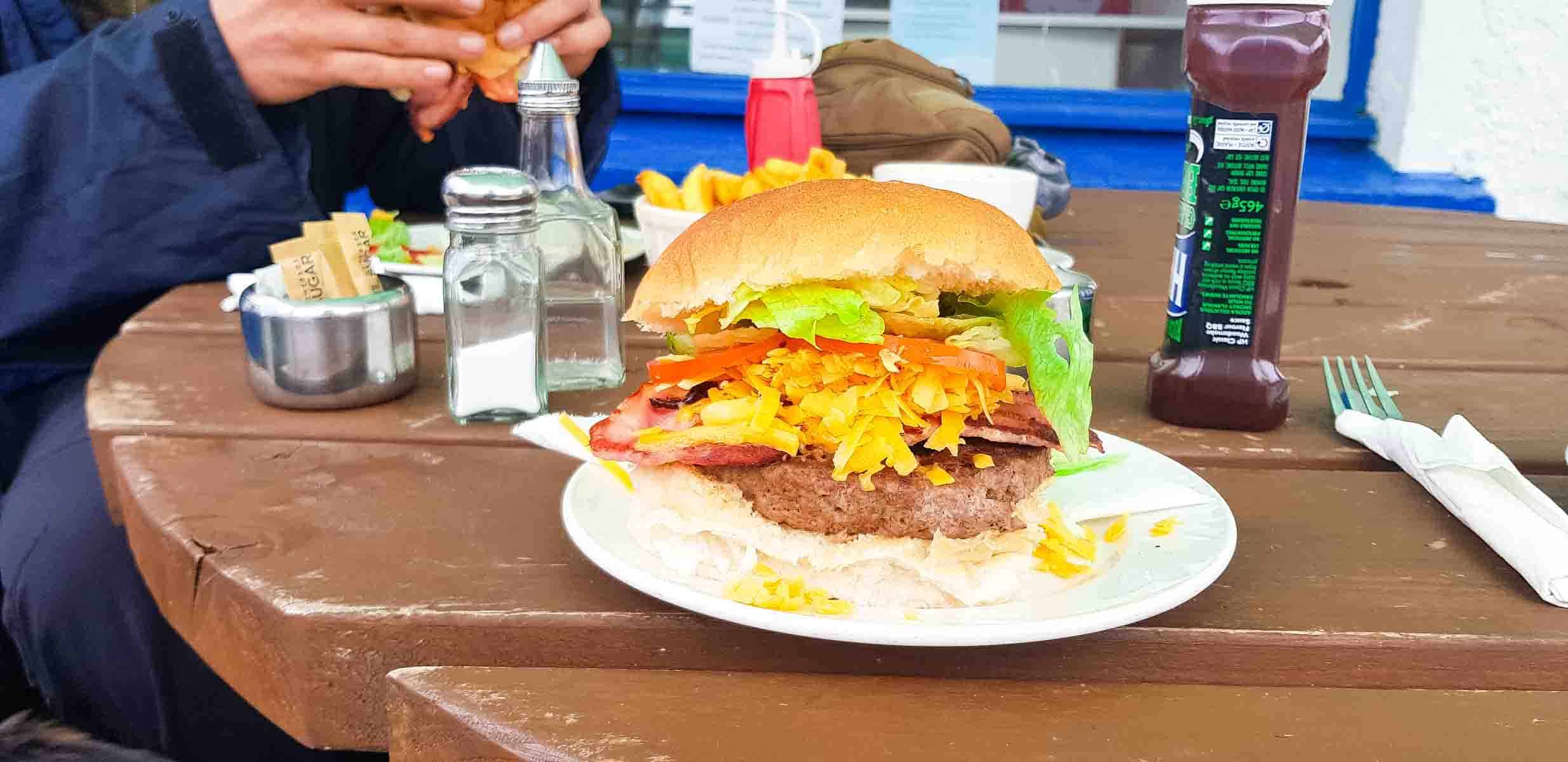 Supporting local cafes in Lochcarron, eating burger and chips at Waterside cafe