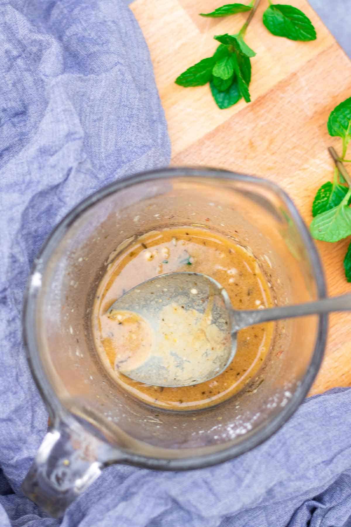 Sausage casserole sauce mixed with plain flour in a jug to thicken in the pot