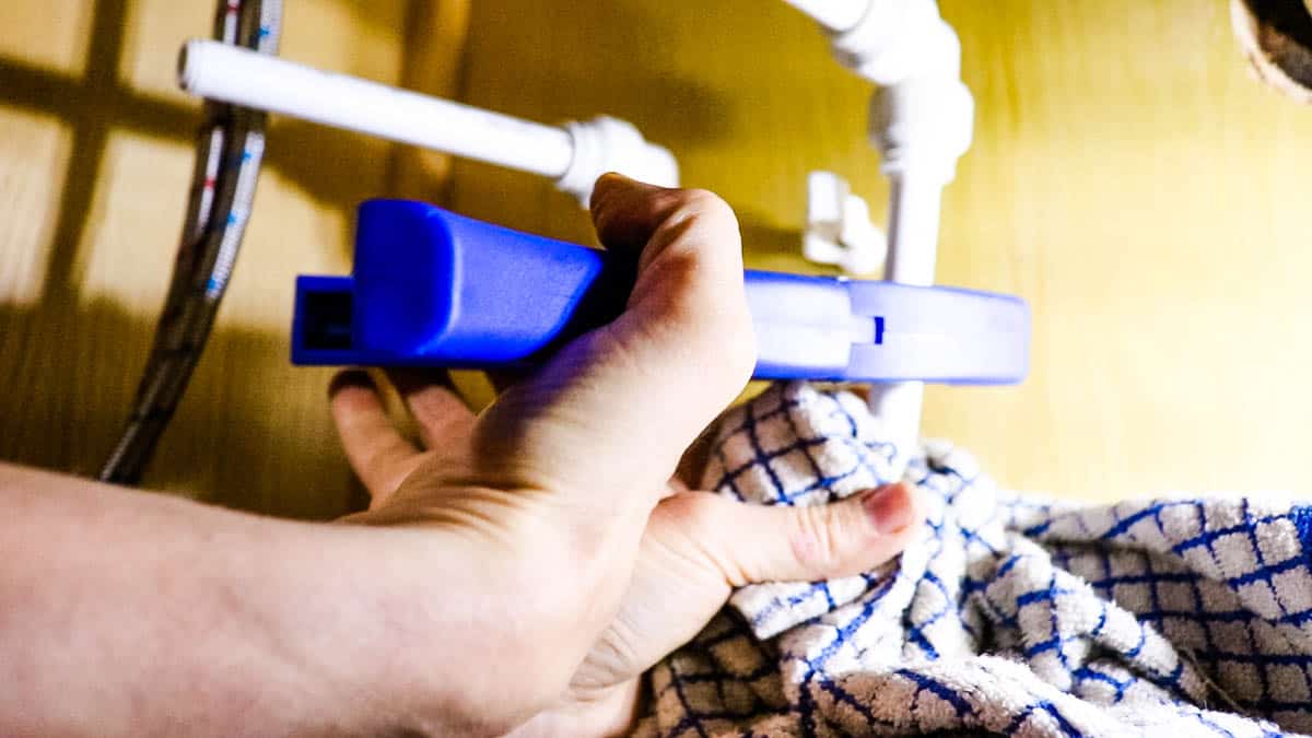 Cutting speedfit with plastic plumbing pipe cutters under a sink