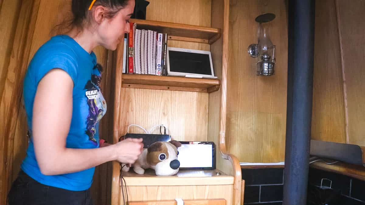 Woman stood front of internet and TV hub on boat