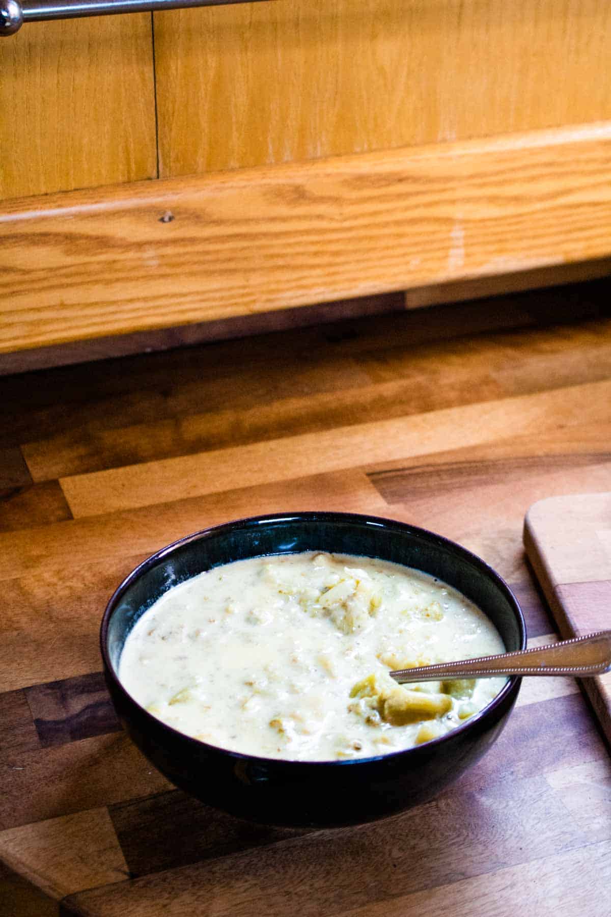 Bowl of soup on a wooden butcher block kitchen worktop in a narrowboat
