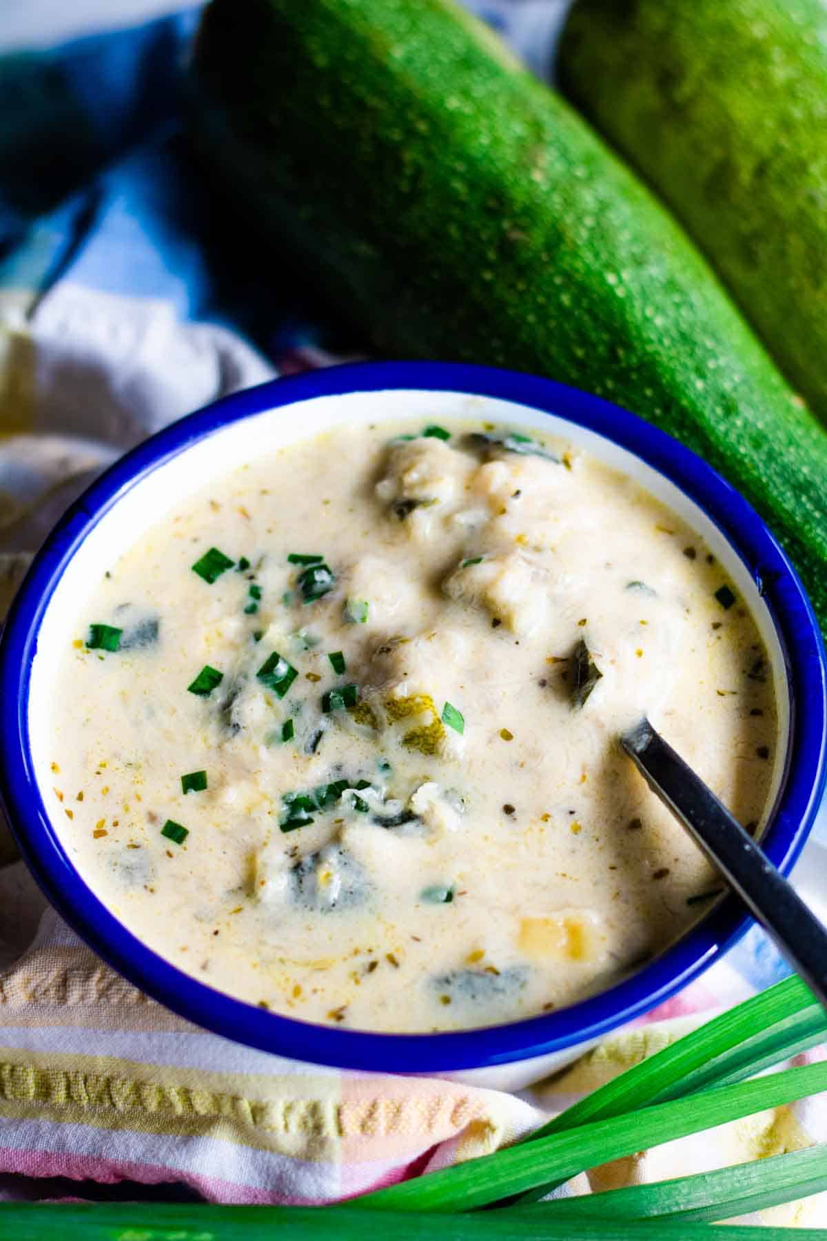 Close up of chunky but creamy vegetarian courgette and cheddar soup.