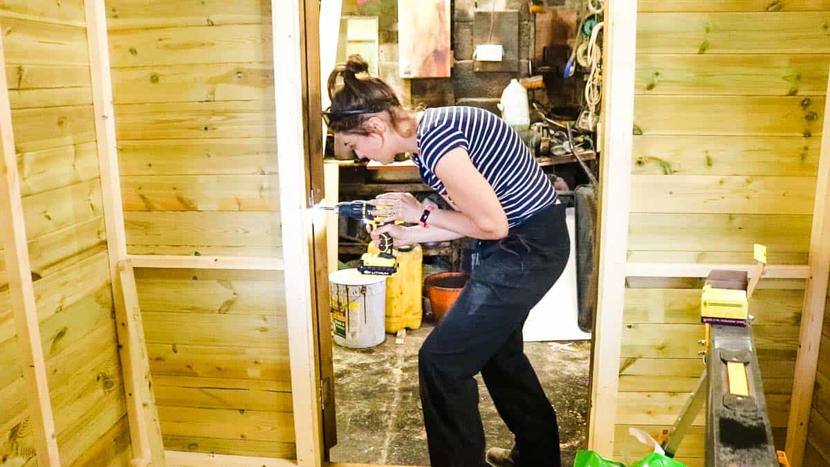 Hanging shed door by hinges with a Stanley fatmax drill