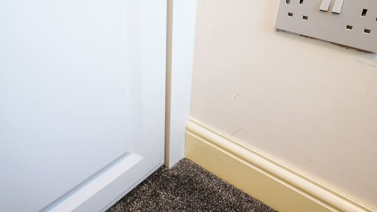 Finished reveal of caulked trim pieces on fitted closet