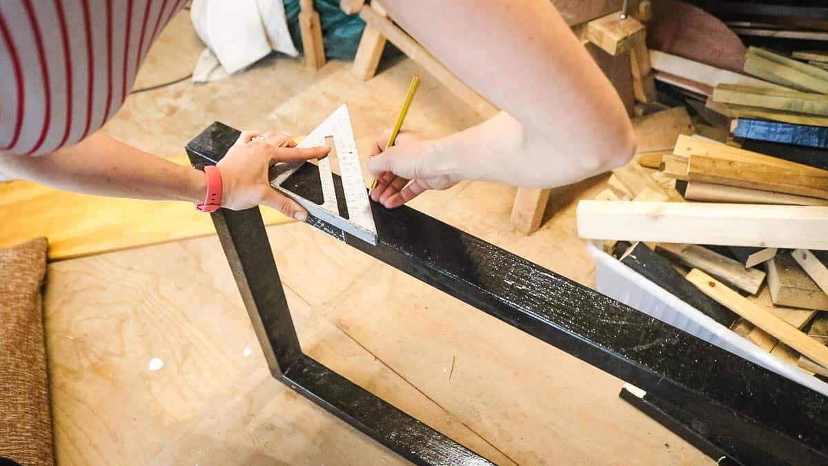 Drawing along a speed square before cutting a mitre for pet bed DIY