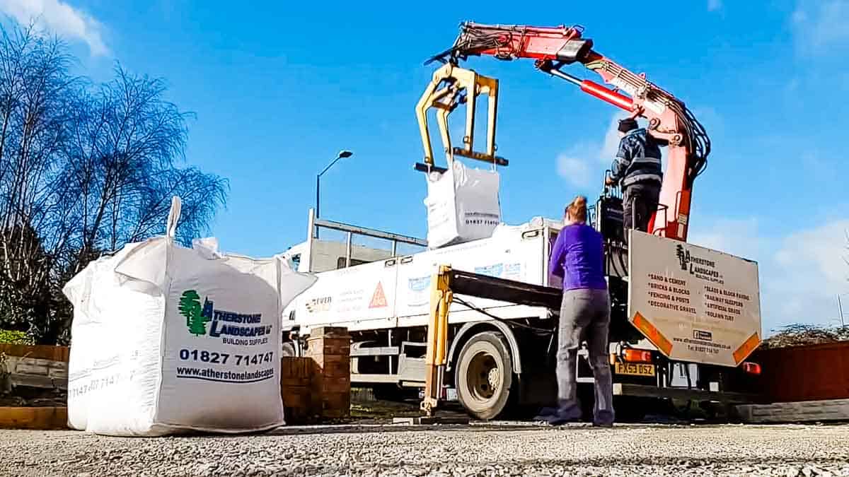 Lorry craning tonnes bags for a gravel driveway installation
