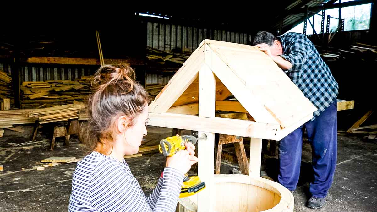 woman drilling a wishing well handle hole