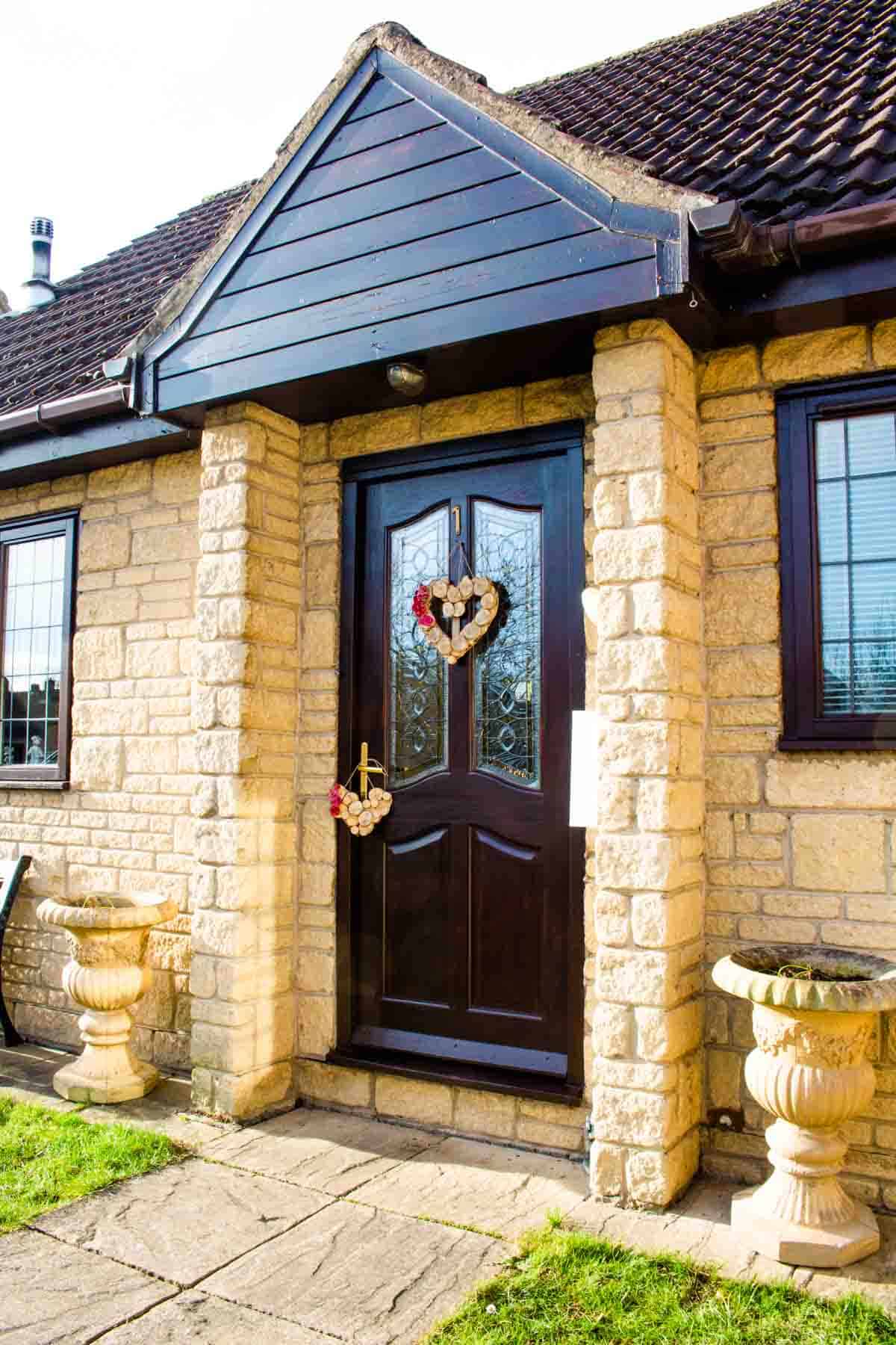 House with a valentine's day wreath DIY hanging on the front door