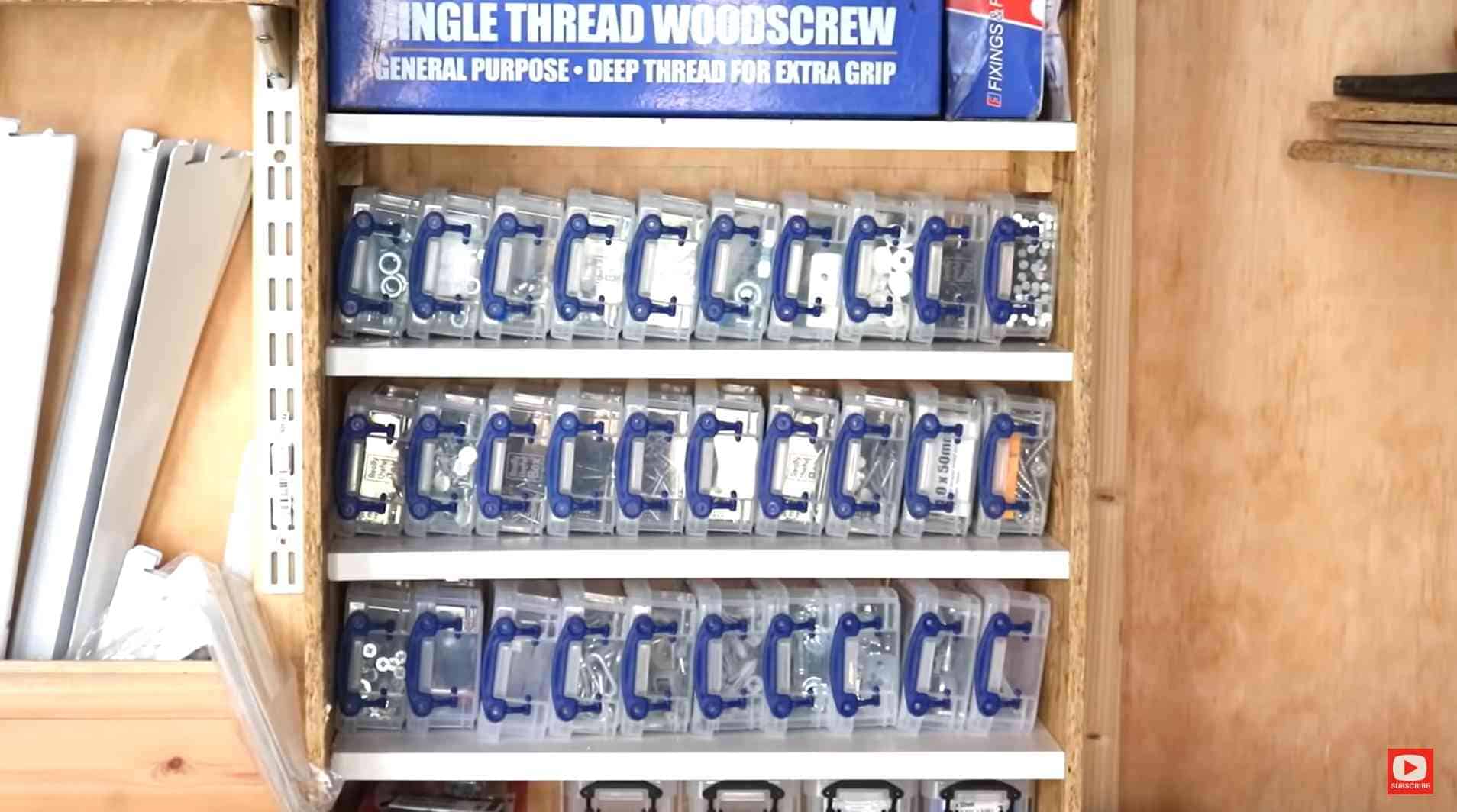 homemade shelves in a shed with little plastic boxes for screws