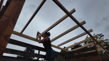 Securing a rafter across the roof frame.